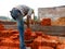 Asian labour arranging bricks for transportation at construction site in India dec 2019