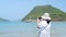 Asian lady try to take a picture at the beautiful sea and beach. Island at BG