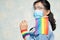 Asian lady wearing blue jean jacket or denim shirt and holding rainbow color flag, symbol of LGBT pride month celebrate annual in