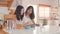 Asian Lesbian lgbtq women couple have breakfast at home, Young Asia lover girls happy using mobile phone talk with friend while