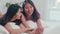 Asian Lesbian lgbtq women couple talking on bed at home. Young Asia lover female happy relax rest together after wake up while