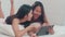 Asian Lesbian lgbtq women couple using tablet at home. Young Asia lover female happy relax rest together after wake up, watching