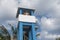 An asian lifeguard on top of a tall watchtower with clear views of the beach. Safety at a tourist spot