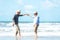 Asian Lifestyle senior couple dancing on the beach happy and relax time.