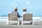 Asian Lifestyle senior couple sitting on the chair beach.  People old happy in love romantic and relax time on the sand beach.