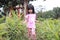 Asian little baby girl playing in cultivation area, ginger or vegetable plantation