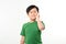 Asian little boy standing with his hand on his mouth suffering from a sore tooth, Isolated over white