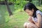 Asian little child girl feeling stressed,female worried bites finger nails in outdoor park,girl patient with nervous expression,