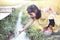 Asian little child girl having fun to play with water stream