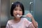 Asian Little Chinese Girl brushing her teeth