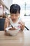 Asian little Chinese girl eating braised pork rice