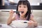 Asian little Chinese girl eating noodles soup