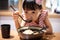 Asian little Chinese girl eating ramen noodles