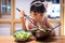 Asian little Chinese girl eating ramen noodles