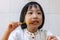 Asian Little Chinese Girl eating satay