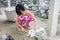 Asian Little Chinese Girl Feeding a Rabbit with Carrot