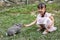 Asian Little Chinese Girl Feeding a Rabbit with Carrot