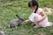 Asian Little Chinese Girl Feeding a Rabbit with Carrot