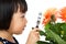 Asian Little Chinese Girl Looking at Flower through a Magnifying