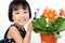 Asian Little Chinese Girl Looking at Flower through a Magnifying