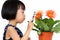 Asian Little Chinese Girl Looking at Flower through a Magnifying