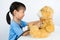 Asian Little Chinese Girl Playing Doctor with Teddy Bear