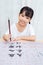 Asian little Chinese girl practice Chinese calligraphy