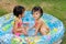 Asian Little Chinese Girls Playing in an Inflatable Rubber Swimming Pool