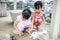 Asian Little Chinese Sisters Feeding a Rabbit with Carrot