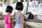 Asian Little Chinese Sisters Feeding Rabbits with Carrot