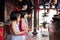 Asian Little Chinese Sisters and mother praying with burning incense sticks