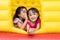 Asian Little Chinese sisters playing at inflatable castle