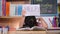 Asian little girl feeling sad and tired sitting at the table with many books and holding a paper with word Help. Learning difficul