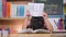 Asian little girl feeling sad and tired sitting at the table with many books and holding a paper with word Help. Learning difficul