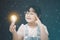 Asian Little girl holding light bulb in the black background, ideas with innovative technology and Electricity, education and peop