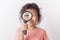 Asian little girl holding magnifying glass smiling. A Little cute child girl looking magnifying glass on white background