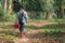 Asian little girl holding red watering tree walking in nature. First learning of little children. Happy family concept.