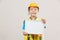 Asian Little Girl or Kids in Blue shirt and Yellow Hardhat standing and holding whiteboard in hand