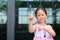 Asian little girl posture pointing her forefinger beside with cute smile