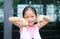 Asian little girl posture pointing her forefinger down with little smile