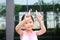 Asian little girl posture pointing her forefinger up with little smile