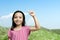 Asian little girl raised hands with a blue sky background