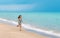 Asian little girl is running on the beautiful beach, motion blur, smiling face, wearing cute dress, black long hair, 7 years old,