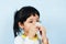 Asian little girl sick wrapped in handkerchief get cold and blow nose the flu season - child runny nose and sneezing blowing their