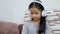 Asian little girl using white wireless headphone with happiness