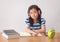 Asian little girl writeing a book and headphones listening to music