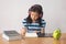 Asian little girl writeing a book and headphones listening to music