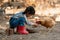 Asian little girl and young woman feed the chicken in layer and house farm eggs.