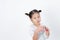 Asian little kid girls are cute, stand smiling on white background.