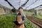 Asian local farmer growing salad lettuce and checking growth rate inside the greenhouse using organics soil approach for family